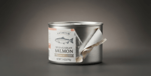 A salmon tin with product label peeling off.